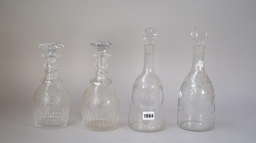 Two sugarloaf glass decanters and stoppers, one with a label engraved for `Port', the other for `White Wine', 19cm. and 19.5cm. high; also a pair of P