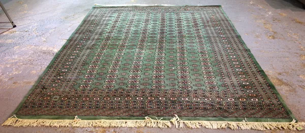 A green Pakistan Bokhara carpet, 306cm x 250cm.