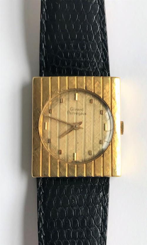 A Girard Perregaux 18ct yellow gold wristwatch of rectangular design, the circular striped dial with applied baton indicators, to a rectangular ribbed