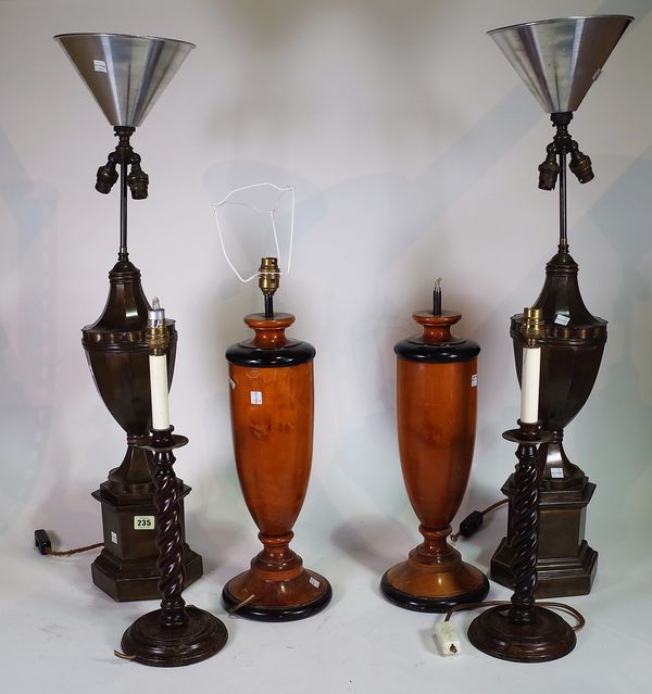 Lighting, comprising; 20th century, a pair of metal urn shaped lamps on octagonal plinth bases, 85cm high, a pair of hardwood lamps on ebonised plinth