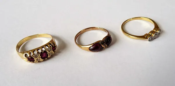 A Victorian carbuncle garnet, rose diamond and colourless gem set ring, in a twist design, a gold and platinum, diamond set three stone ring and a gol