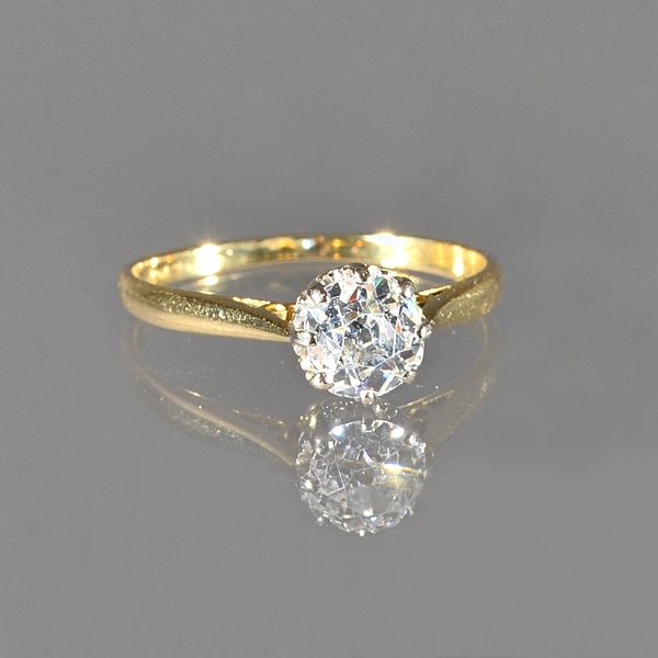 A gold and diamond single stone ring, claw set with a cushion shaped diamond, ring size M, gross weight 2.1 gms. Illustrated.