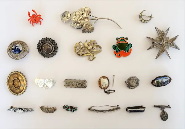 A collection of twenty silver and other brooches, including; a foliate spray, an oval shell cameo, a marcasite set Navy crown and a filigree Maltese c