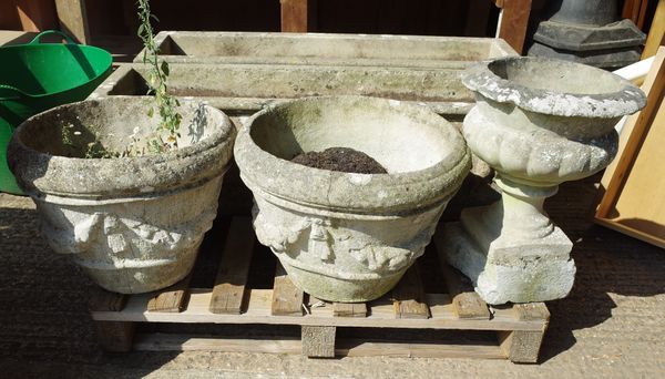 Garden statuary; a pair of 20th century reconstituted stone garden urns with swag decoration, 46cm wide x 38cm high, and an urn on plinth base, 34cm w