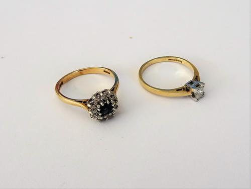 A 9ct gold ring, claw set with a square cut sapphire to the centre, in a surround of twelve circular cut diamonds, ring size K and a 9ct gold ring, cl