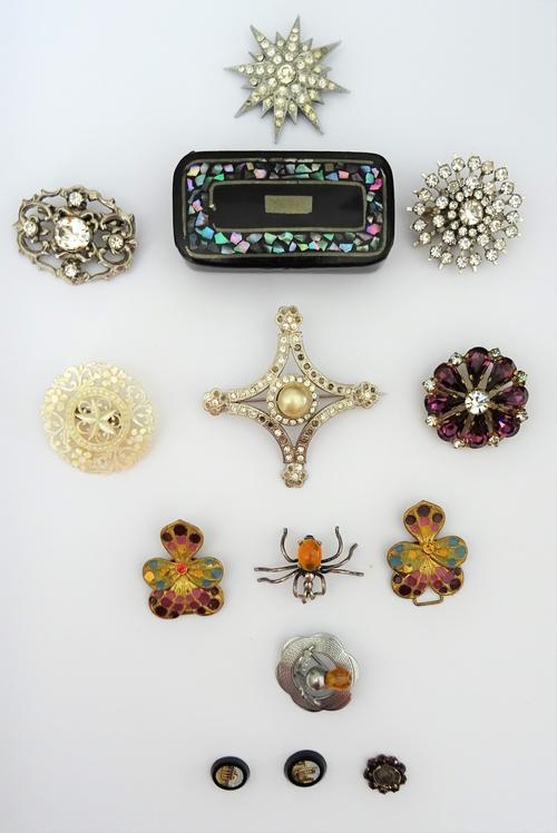 Two unmounted oval small miniature micro-mosaic panels, a Bohemian garnet set fitting, seven brooches, a buckle designed as a pansy and a papier-mache