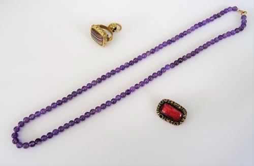 A Victorian banded agate set pendant fob seal, having floral decoration, a curved rectangular brooch, glazed with a locket compartment within a floral