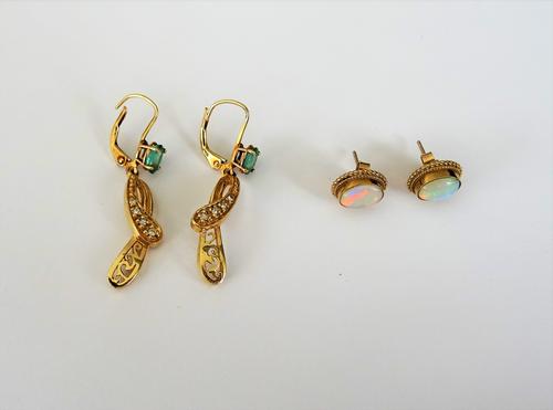 A pair of 9ct gold and opal single stone earstuds, each mounted with an oval opal within a ropetwist wirework surround, the backs with post and butter