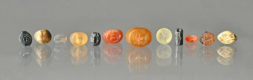 A collection of twelve Ancient mostly agate intaglios, probably Mesopotamian and Sasanian, 5th century and later, including pierced bead form and one