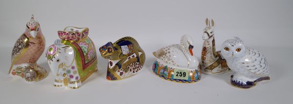 Six Royal Crown Derby Imari paperweights including a llama, swan, chameleon, parrot, elephant and owl, all boxed, (6). CAB