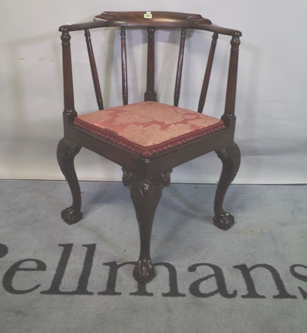 A late George III mahogany corner armchair on ball and claw supports, 63cm wide x 81cm high.