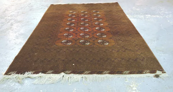 An Afghan carpet, three columns of seven guls, 303cm x 203cm.