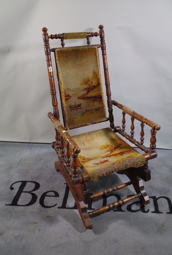 A 19th century beech framed American rocking chair, 66cm wide x 109cm high.