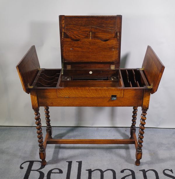 Britisher; a mid-20th century oak folding writing desk on barleytwist supports, 91cm wide x 77cm high.