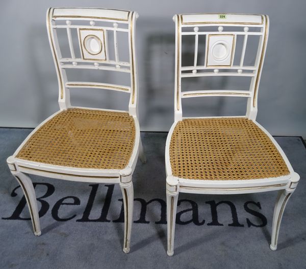 A pair of Regency style white painted side chairs on sabre supports, 40cm wide x 84cm high, (2).