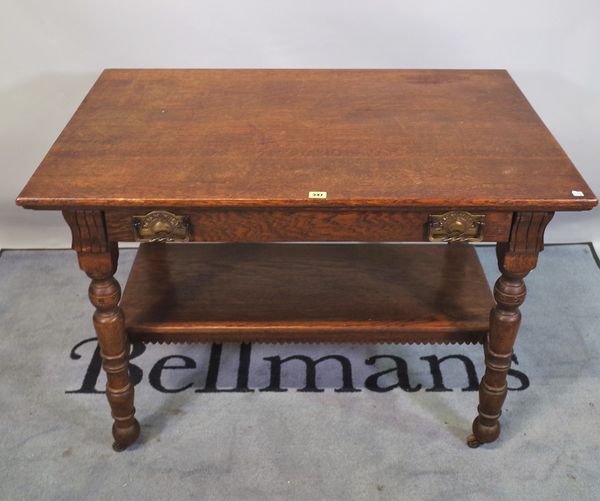 A late 19th century oak Arts & Crafts two tier side table with single drawer, 106cm wide x 76cm high.