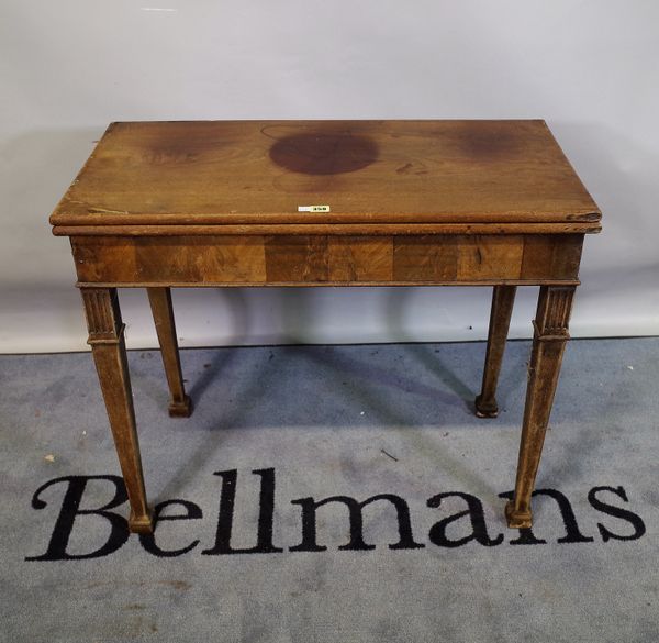 A late George III mahogany foldover tea table on tapering square supports, 86cm wide x 72cm high.