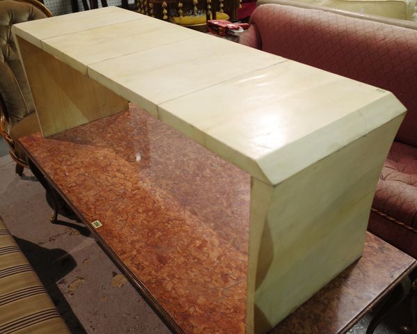 A 20th century white laminate rectangular coffee table on outswept trestle end supports, 130cm wide x 46cm high.