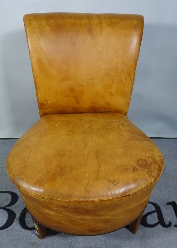 An early 20th century tan leather upholstered low chair, an Edwardian mahogany jardiniere stand, 34cm wide x 54cm high and an early 20th century mahog