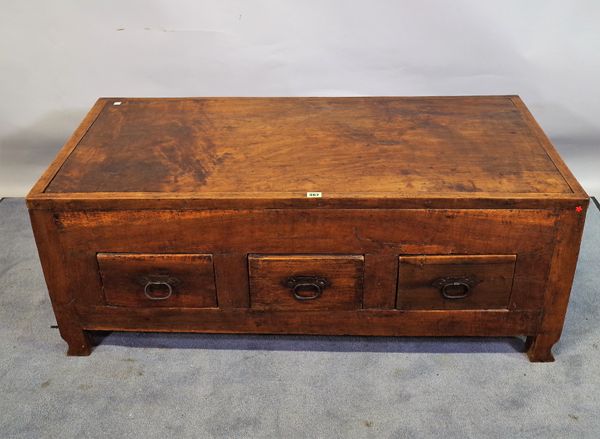 A 20th century hardwood low trunk with three drawers, 120cm wide x 47cm high.