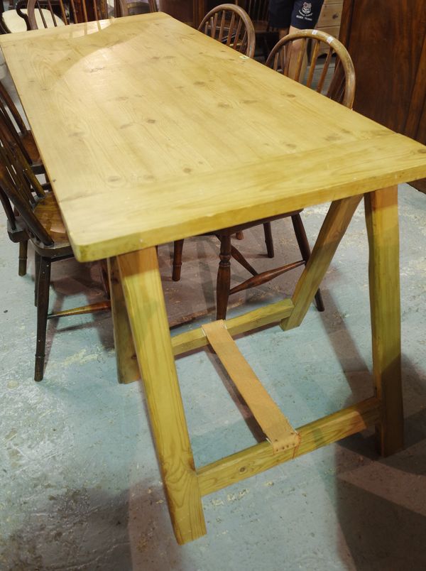 A 20th century pine work table on folding 'A' frame supports, 172cm wide x 80cm high.