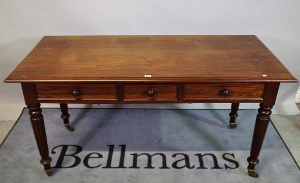 A Victorian mahogany three drawer side table on reeded tapering supports, 143cm wide x 73cm high.