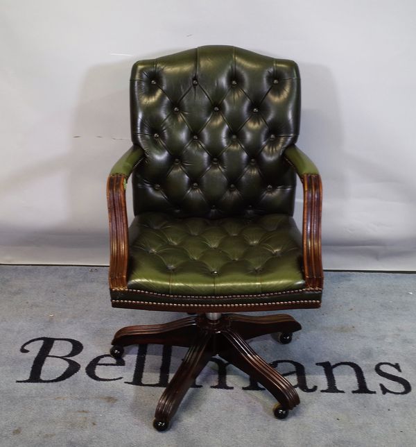 A 20th century Gainsborough style office open armchair with faux green leather button back upholstery, 57cm wide x 94cm high.