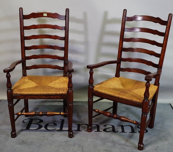 A set of eight 18th century style oak Lancashire ladder back dining chairs, to include two carvers, 41cm wide x 104cm high(8).