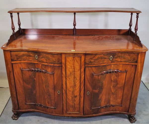 A 19th century Continental mahogany side cabinet with two drawers over moulded cupboard doors on claw feet, 147cm wide x 140cm high.