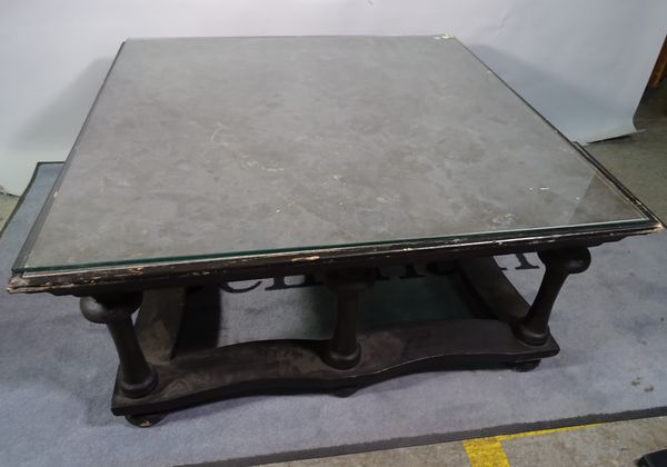 An ebonised square coffee table with marble inset top on turned supports, 103cm wide x 48cm high.