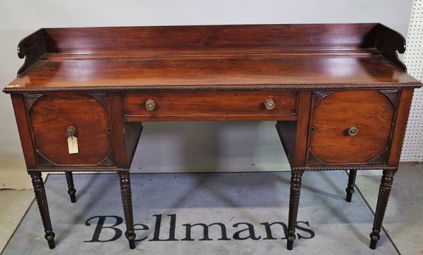 A Regency mahogany sideboard, possibly Irish, the 3/4 galleried back over drawer, flanked by cupboards, alterations, 180cm wide x 117cm high.