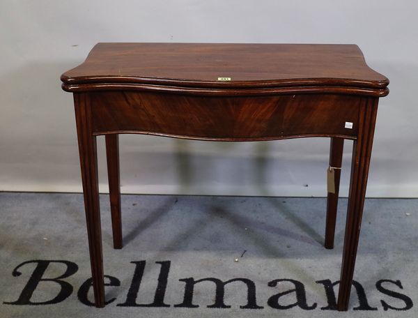 An 18th century mahogany serpentine tea table on square supports, 84cm wide x 73cm high.