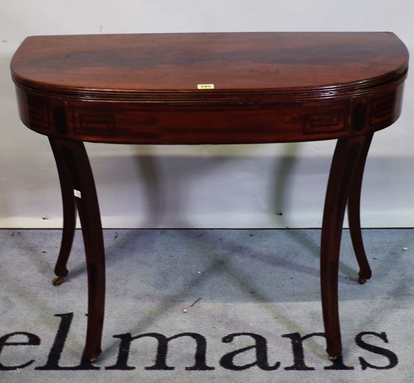 A 19th century Continental mahogany 'D' shaped tea table, on sabre supports, 91cm wide x 73cm high.