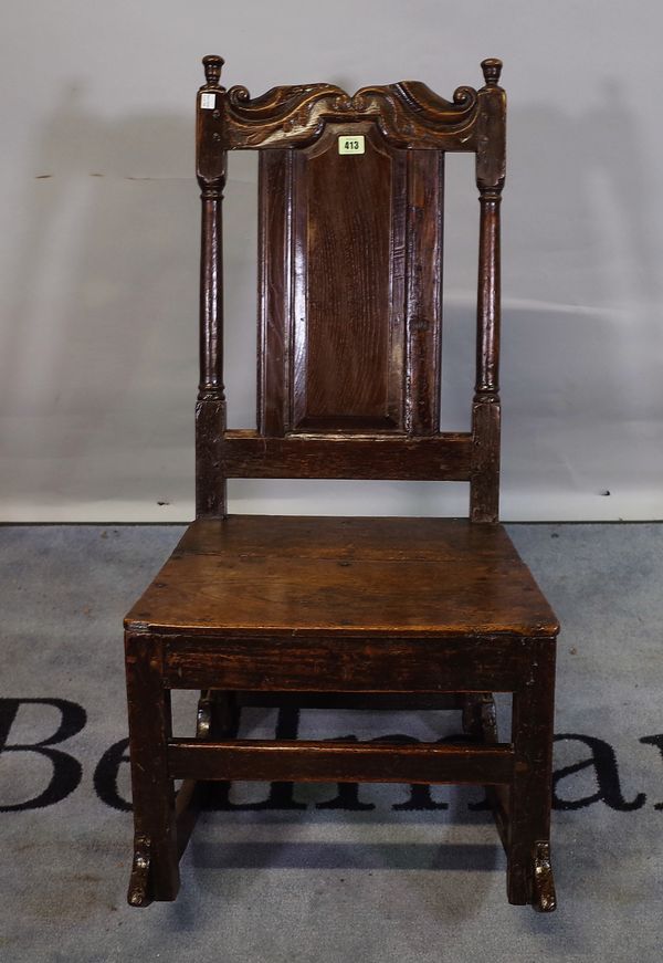 An 18th century and later oak low rocking chair, 46cm wide x 87cm high.