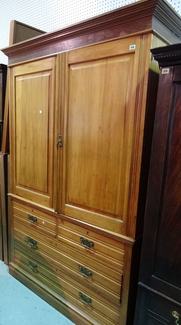 A late Victorian faded walnut linen press with cupboard doors over two short and two long drawers on plinth base, 132cm wide x 240cm high.