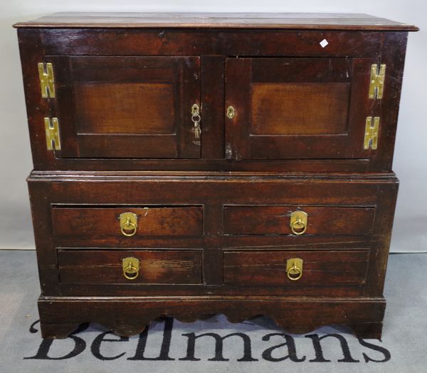 An 18th century oak low cupboard with cupboard top section over four drawers on bracket feet, 118cm wide x 107cm high.