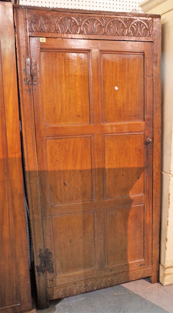 An 18th century and later oak floor standing cupboard with panelled doors, 89cm wide x 127cm high.