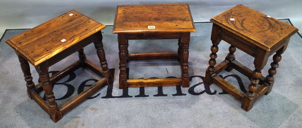 A pair of 17th century style yew wood joint stools, 38cm wide x 37cm high, and another oak stool, (3).