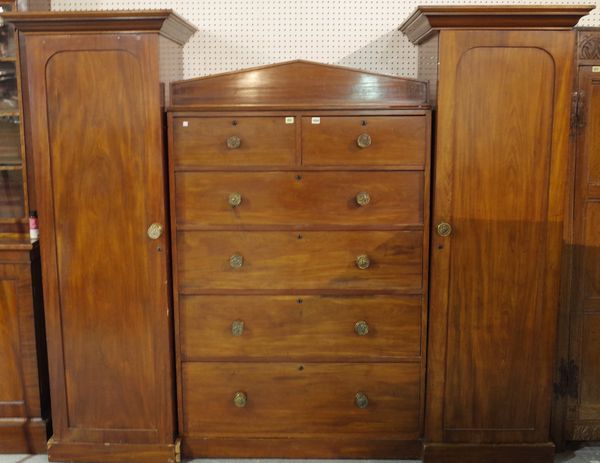 A Victorian mahogany sentry wardrobe, with two short and four long graduated drawers, flanked by hanging cupboards, 192cm wide x 225cm wide.