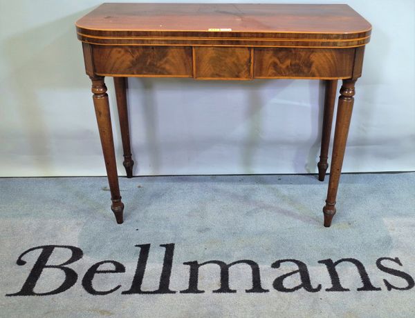 A George III mahogany card table, the 'D' shape top on turned supports, 92cm wide x 74cm high.