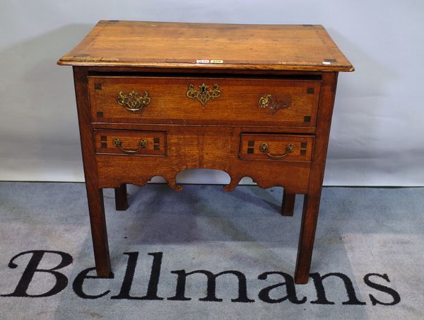 An early 18th Century oak lowboy, with crossbanded rectangular top with unusual inlay, 71cms high, 76cms wide.