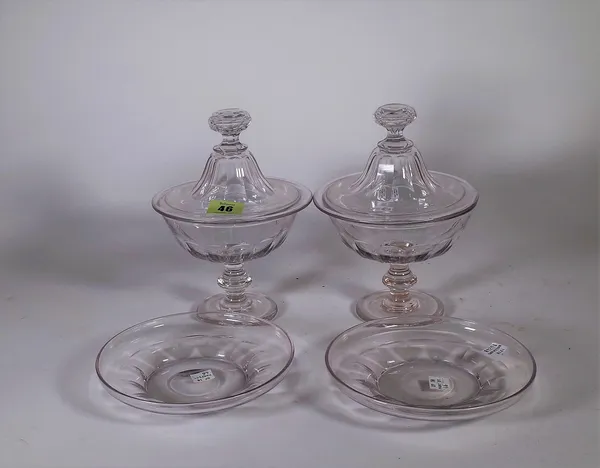 A pair of glass bon bon dishes, covers and stands, possibly French, circa 1870, circular form, the domed covers with facet cut knops, 21.5cm. high, (6
