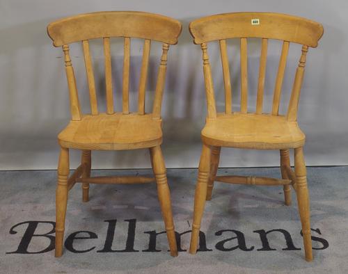 A pair of 20th century beech stick back dining chairs, (2).