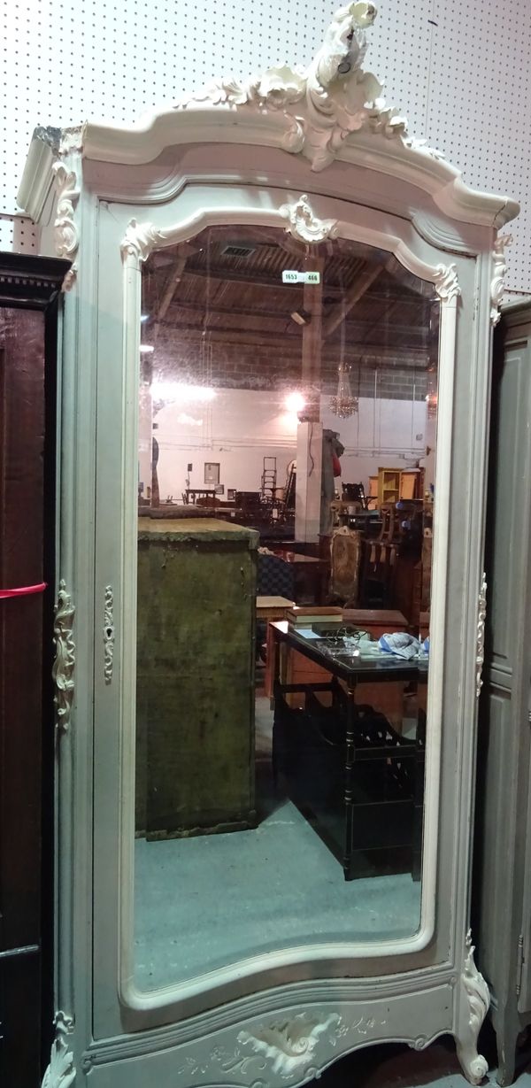 An 18th century style French wardrobe, with scroll crest over bevelled mirror door, 111cm wide x 240cm high.