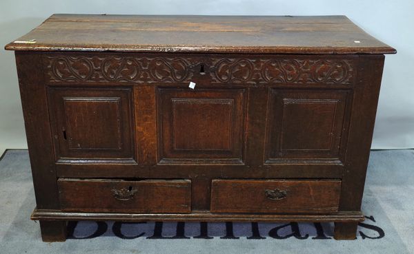 An 18th century oak mule chest, the lift top over triple panel front and pair of drawers, 121cm wide x 72cm high.