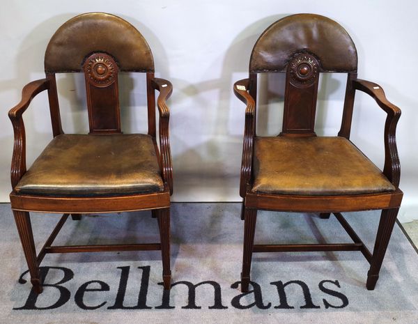 A set of six late 19th century mahogany dining chairs, with arch backs and sunflower carved splat, on tapering square supports, number stamped to unde