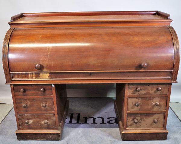 A Victorian mahogany roll top desk with fitted interior over six pedestal drawers, 152cm wide x 117cm high.