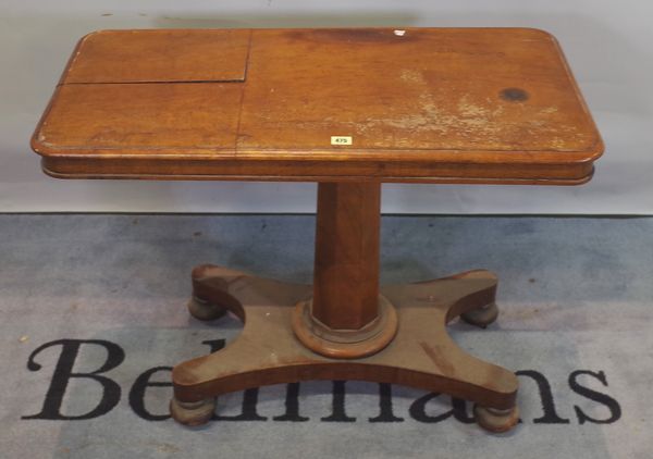 A Regency mahogany reading table on quatrefoil base and bun feet, 91cm wide x 70cm high.