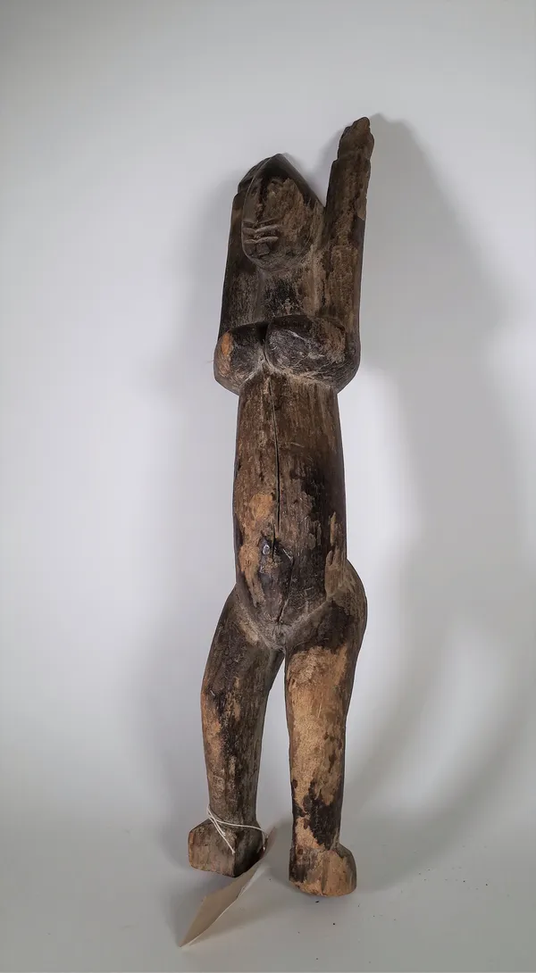 A Dogan tribal wooden figure, depicted standing with arms outstretched (a.f.), 71cm high. S1M