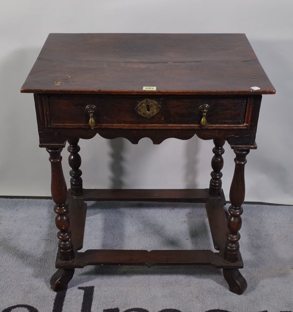 An 18th century oak single drawer side table on turned supports united by stretchers, 61cm wide x 68cm high.